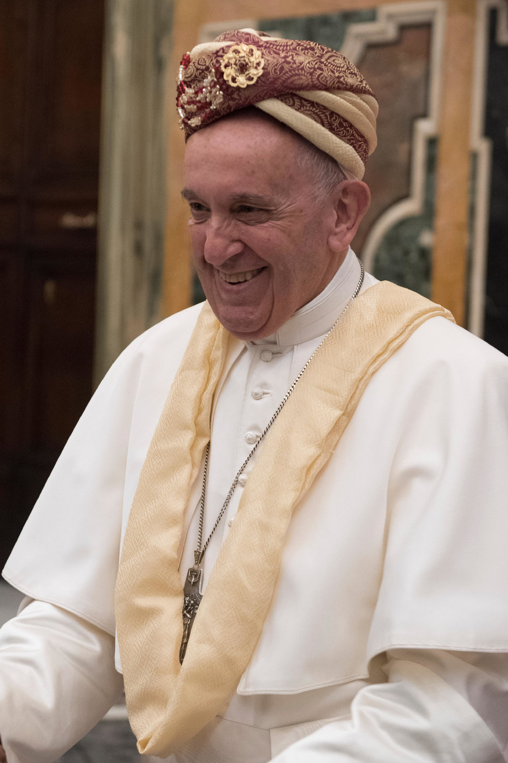 Pope Francis smiles while wearing a turban after it was presented to him during a meeting April 26, 2019, at the Vatican with members of the Catholic Biblical Federation celebrating their organization’s 50th anniversary.